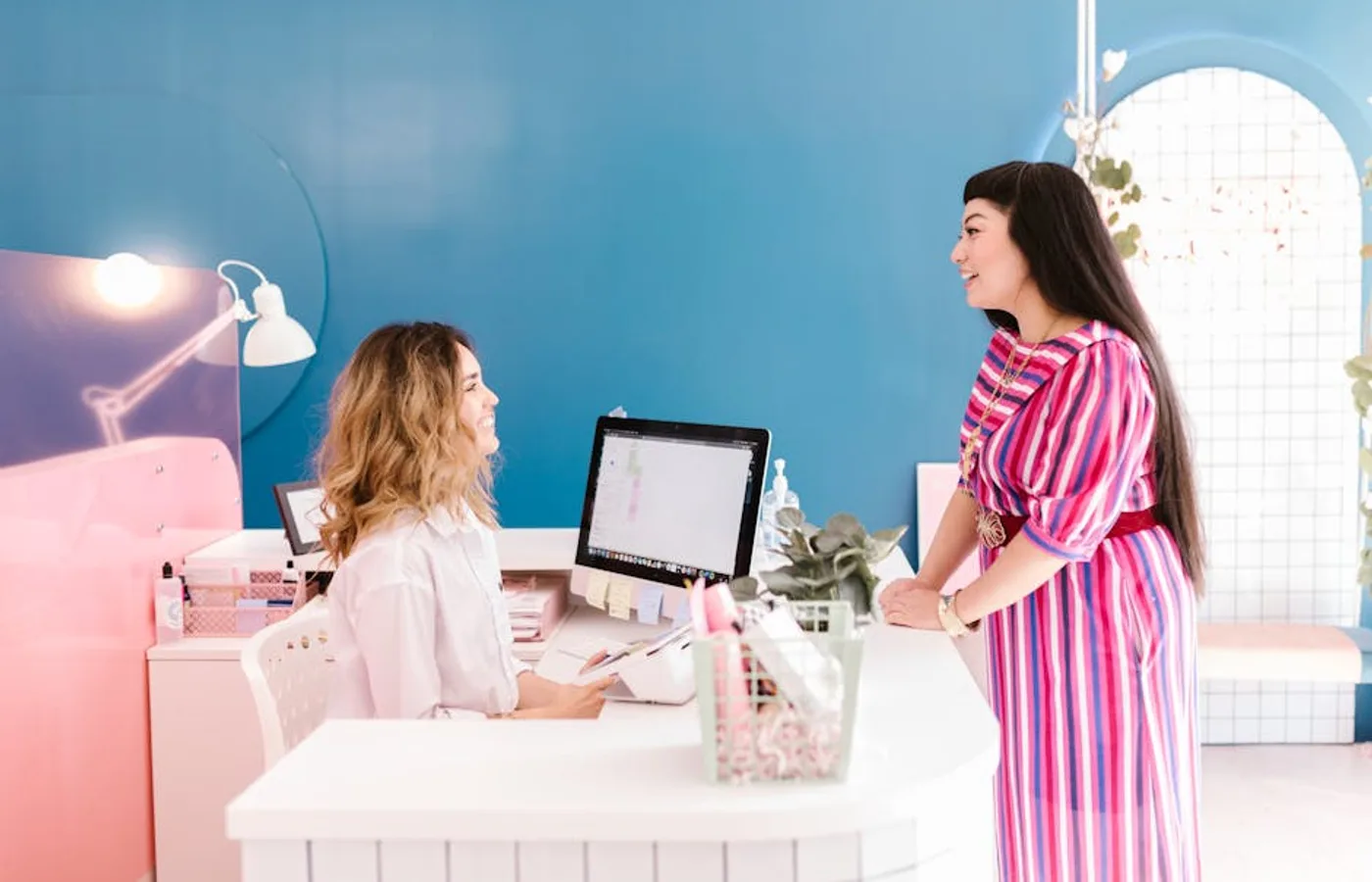 Nail technician consulting with a client before service